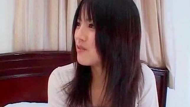 Seductive Brunette Teases Pussy with Vibrator on Bed