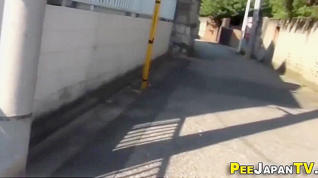 Asian JAV Star Urinates Outdoors in Seductive Car Park Showdown